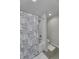 Contemporary bathroom featuring a shower-tub combination with a patterned curtain at 8740 Morgan Dr, Fishers, IN 46038