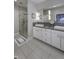 Bright bathroom featuring double vanity with modern sinks, walk-in shower, and large mirror at 8740 Morgan Dr, Fishers, IN 46038