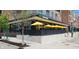 Exterior view of Agave Bar & Grill, featuring a modern brick building with yellow umbrellas on the patio at 8740 Morgan Dr, Fishers, IN 46038