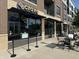 Modern exterior of Crave restaurant, featuring dark awnings, glass windows, and outdoor seating at 8740 Morgan Dr, Fishers, IN 46038
