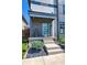 Charming home entrance featuring a modern blue door, concrete steps, and black rock landscaping at 8740 Morgan Dr, Fishers, IN 46038