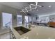 View of kitchen island overlooking patio seating, open concept to dining and living room at 8740 Morgan Dr, Fishers, IN 46038