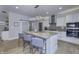 Modern kitchen featuring a large island, stainless steel appliances, and contemporary lighting fixtures at 8740 Morgan Dr, Fishers, IN 46038