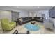 Bright living room with large leather sectional sofa, accent chair and a painted barn door at 8740 Morgan Dr, Fishers, IN 46038