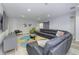 Well lit living room with gray sectional, tv, accent chair, and custom barn door at 8740 Morgan Dr, Fishers, IN 46038