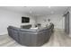 Modern living room with a gray sectional sofa, accent chair and entertainment center at 8740 Morgan Dr, Fishers, IN 46038