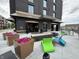 Enjoy the vibrant outdoor patio with colorful seating, modern fire features, and lush floral displays at 8740 Morgan Dr, Fishers, IN 46038
