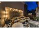 Inviting outdoor patio area with comfortable seating, ambient lighting, and a stylish decorative screen creating a relaxing atmosphere at 8740 Morgan Dr, Fishers, IN 46038