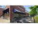 Chatham Tap outdoor dining area featuring brick facade, striped awnings, and inviting seating arrangements at 8740 Morgan Dr, Fishers, IN 46038
