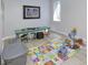Bright playroom with colorful ABC mat, painting and bench, perfect for activities at 8740 Morgan Dr, Fishers, IN 46038