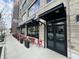 A restaurant exterior with black awnings, doors, flower boxes, and red patio seating are visible at 8740 Morgan Dr, Fishers, IN 46038