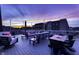 Open roof deck with comfortable seating, a dining table, and stunning sunset views over the neighborhood at 8740 Morgan Dr, Fishers, IN 46038