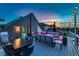 Charming roof deck featuring comfortable seating, dining space, and vibrant evening sky views at 8740 Morgan Dr, Fishers, IN 46038