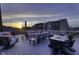 Roof deck with comfortable seating, a dining table, and beautiful sunset views overlooking the urban landscape at 8740 Morgan Dr, Fishers, IN 46038