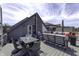 Open rooftop deck with modern outdoor furniture, dining space, and views of neighborhood at 8740 Morgan Dr, Fishers, IN 46038