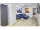 Beautiful sitting room featuring a blue sofa, ottoman, area rug and artwork on the walls at 8740 Morgan Dr, Fishers, IN 46038