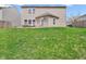 A well-maintained backyard featuring a lush lawn, patio furniture, and space for outdoor activities at 8813 Browns Valley Ln, Indianapolis, IN 46113