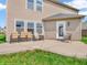 Back patio featuring neutral toned lawn furniture overlooking a grassy yard at 8813 Browns Valley Ln, Indianapolis, IN 46113