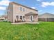 The house has a large backyard with chairs and grass, and could be used for many outdoor activities at 8813 Browns Valley Ln, Indianapolis, IN 46113