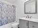Cozy bathroom features a shower-tub, vanity, and a decorative mirror at 8813 Browns Valley Ln, Indianapolis, IN 46113