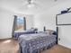 Bedroom featuring two twin beds and a window providing natural light at 8813 Browns Valley Ln, Indianapolis, IN 46113