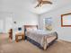 Bedroom with a bed, ceiling fan and view to the backyard through the window at 8813 Browns Valley Ln, Indianapolis, IN 46113