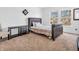Bedroom with sleek black furniture set and two windows providing natural light at 8813 Browns Valley Ln, Indianapolis, IN 46113