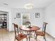 Bright dining area with a wooden table, chairs, and a modern light fixture, perfect for intimate meals at 8813 Browns Valley Ln, Indianapolis, IN 46113