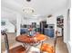 Open dining area with stylish table, leading to a modern kitchen and living space at 8813 Browns Valley Ln, Indianapolis, IN 46113