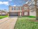 Charming two-story home featuring a brick and vinyl exterior, attached garage, and well-maintained front lawn at 8813 Browns Valley Ln, Indianapolis, IN 46113