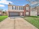 Charming two-story home featuring a brick and vinyl exterior, attached garage, and well-maintained front lawn at 8813 Browns Valley Ln, Indianapolis, IN 46113