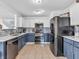 Modern kitchen featuring stainless steel appliances, two-tone cabinetry, and stylish backsplash at 8813 Browns Valley Ln, Indianapolis, IN 46113