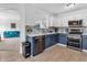 Well-lit kitchen with stainless appliances, two-tone cabinets, and a view of the living room at 8813 Browns Valley Ln, Indianapolis, IN 46113