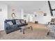 Spacious living room featuring carpet flooring, a modern sofa, and a cozy atmosphere with soft lighting at 8813 Browns Valley Ln, Indianapolis, IN 46113