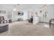 Bright living room with carpet, featuring modern decor and an inviting layout with many windows at 8813 Browns Valley Ln, Indianapolis, IN 46113