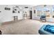 Bright and airy living room featuring large windows, neutral carpet, and an open-concept design at 8813 Browns Valley Ln, Indianapolis, IN 46113
