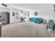 Bright living room with plush furniture, carpet flooring, and a modern stainless steel refrigerator at 8813 Browns Valley Ln, Indianapolis, IN 46113