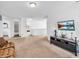Inviting living room featuring a TV, sofa, and open layout, perfect for modern living and entertaining at 8813 Browns Valley Ln, Indianapolis, IN 46113