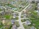 Aerial view of neighborhood displaying the home and nearby lake and park at 9362 Helmsdale Dr, Indianapolis, IN 46256