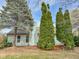Back exterior of home with a wooden deck, large trees, and grass in the backyard at 9362 Helmsdale Dr, Indianapolis, IN 46256