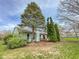 Back exterior of home with a wooden deck and large trees in the backyard at 9362 Helmsdale Dr, Indianapolis, IN 46256