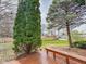 Wooden deck with a bench overlooks spacious backyard with mature trees and wood fence at 9362 Helmsdale Dr, Indianapolis, IN 46256