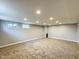Finished basement featuring neutral carpet, gray walls, recessed lighting, and egress windows at 9362 Helmsdale Dr, Indianapolis, IN 46256