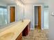 Bright bathroom features a dual vanity, tile flooring, and access to a shower at 9362 Helmsdale Dr, Indianapolis, IN 46256