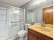 Bathroom with a glass enclosed shower, toilet, and vanity with a yellow countertop at 9362 Helmsdale Dr, Indianapolis, IN 46256