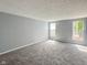 Cozy bedroom with neutral paint, plush carpeting, and natural light from two windows at 9362 Helmsdale Dr, Indianapolis, IN 46256