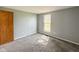 Bedroom with gray walls and carpet, and a window with a view of the backyard at 9362 Helmsdale Dr, Indianapolis, IN 46256