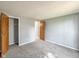 Bedroom with gray walls, gray carpet, closet, and door to another room at 9362 Helmsdale Dr, Indianapolis, IN 46256