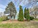 Back exterior view of light blue home with deck and yard with trees at 9362 Helmsdale Dr, Indianapolis, IN 46256