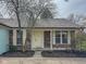 Charming brick ranch home with well-maintained landscaping and a welcoming front porch at 9362 Helmsdale Dr, Indianapolis, IN 46256